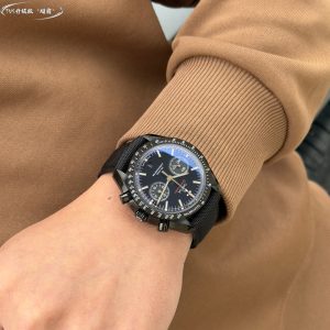 Alternative view of TVS Pioneer Edition: Omega Speedmaster Dark Side of the Moon Watch 311.92.44.51.01.0054 25mm Co-Axial Chronograph, in-house developed 9300 movement 3 o'clock dial features [12-hour] and [30-minute] cumulative chronograph counters All functions and aesthetics meticulously crafted to replicate the original [1-1] model.Movement: 9300 Dual-T Black Balance Wheel, Automatic Co-Axial Master Chronometer Chronograph Movement. Rhodium-plated movement with distinctive Arabic-style Geneva waves. Bezel: Brushed ceramic. Dial: Matte dark gray ceramic dial. Case: Brushed black. Strap: Black nylon fabric strap. Crystal: Double-domed sapphire crystal. Scratch-resistant. Functions: Date display. Chronograph.